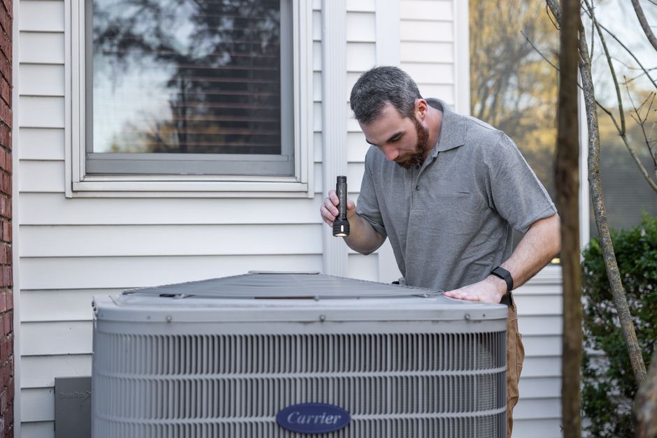 Technician servicing a home furnace